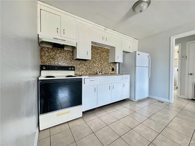 a kitchen with stainless steel appliances a refrigerator sink and cabinets