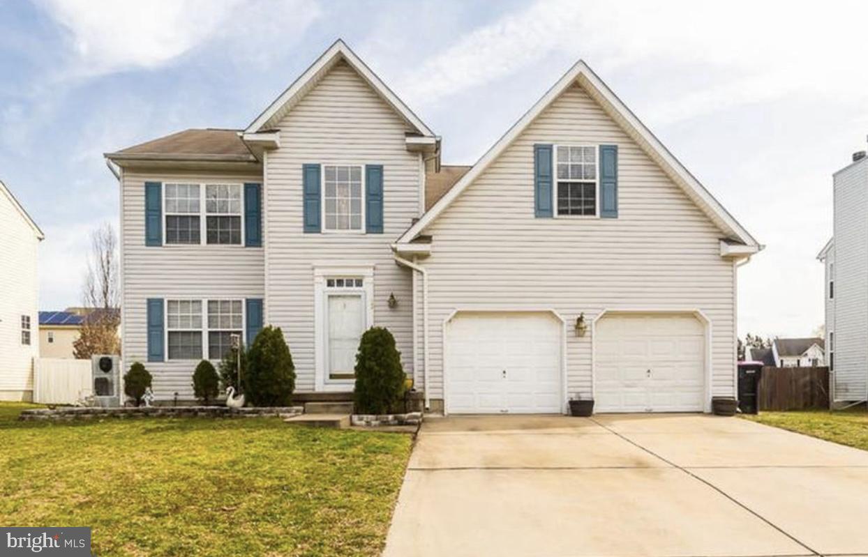 a view of a house with large windows and plants