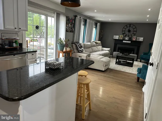 a living room with fireplace furniture and a flat screen tv