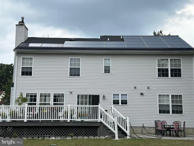a view of a house with a wooden deck