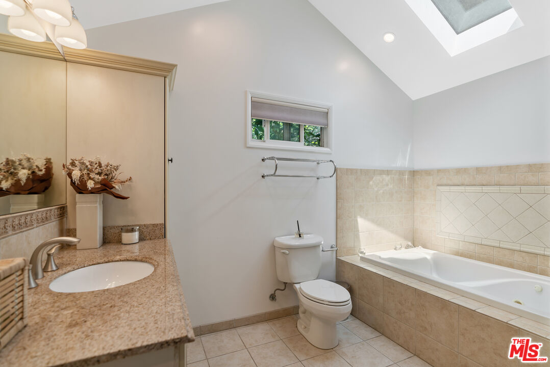 99 Paradise Cove Road Malibu, CA 90265 - Photo 12 of 26 a bathroom with a granite countertop sink toilet and shower