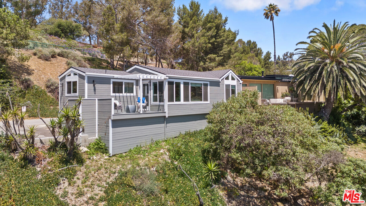99 Paradise Cove Road Malibu, CA 90265 - Photo 15 of 26 a front view of a house with a garden