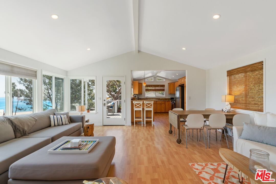 99 Paradise Cove Road Malibu, CA 90265 - Photo 3 of 26 a living room with furniture wooden floor and a large window