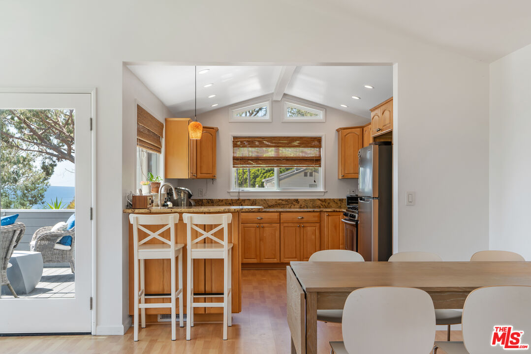 99 Paradise Cove Road Malibu, CA 90265 - Photo 4 of 26 a kitchen with stainless steel appliances granite countertop a stove and a refrigerator