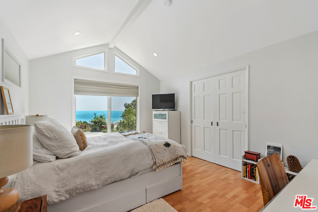 99 Paradise Cove Road Malibu, CA 90265 - Photo 9 of 26 a bedroom with a bed and glass door