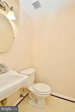 a white toilet sitting next to a bathroom sink