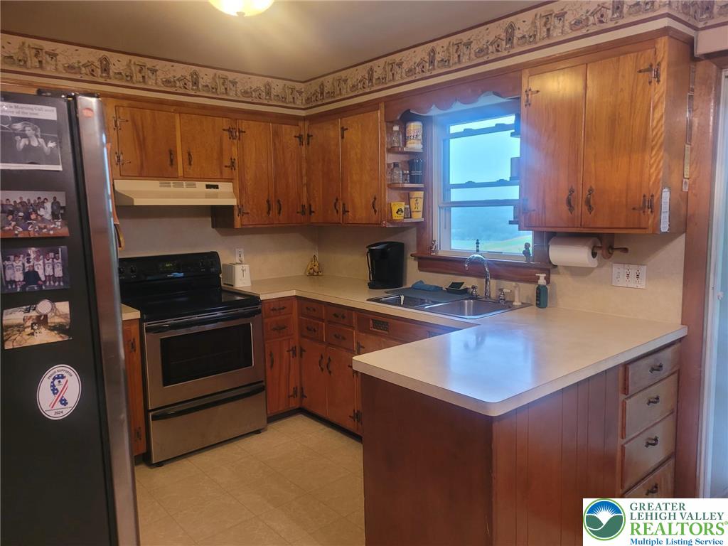 889 Bushkill Center Road Nazareth, PA 18064 - Photo 11 of 31 a kitchen with a sink stove and cabinets