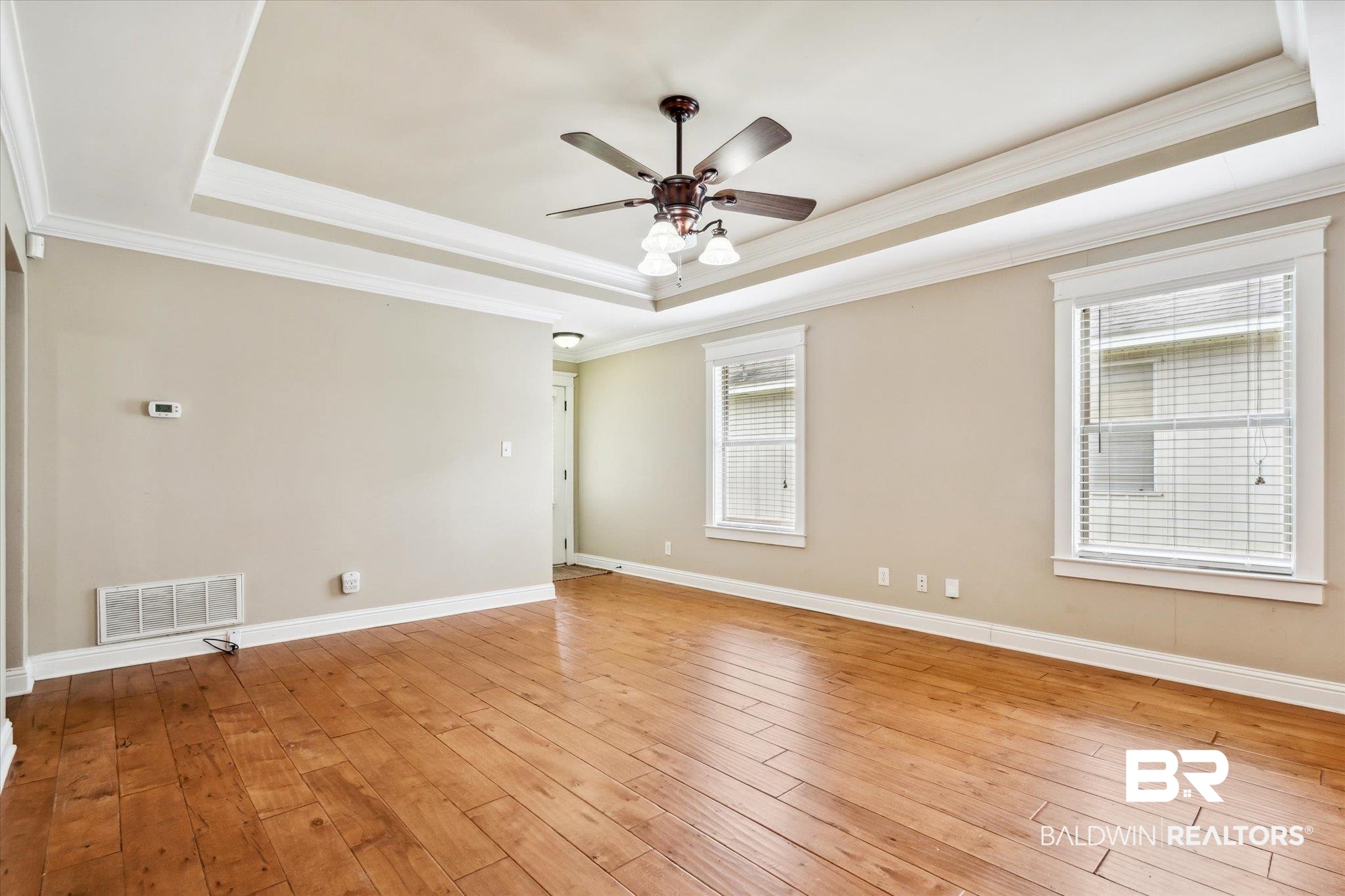 9 Breydon Court Mobile, AL 36608 - Photo 3 of 20 Spare room with crown molding, a raised ceiling, light hardwood / wood-style flooring, and ceiling fan