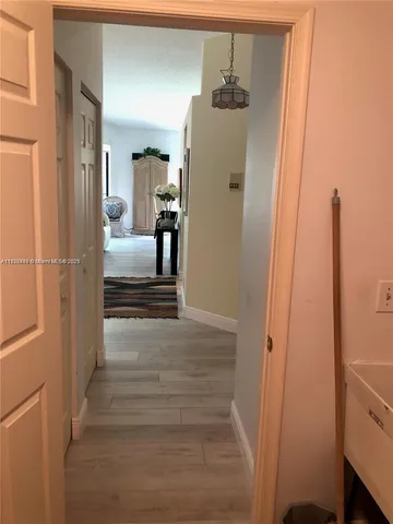 a view of hallway with wooden floor