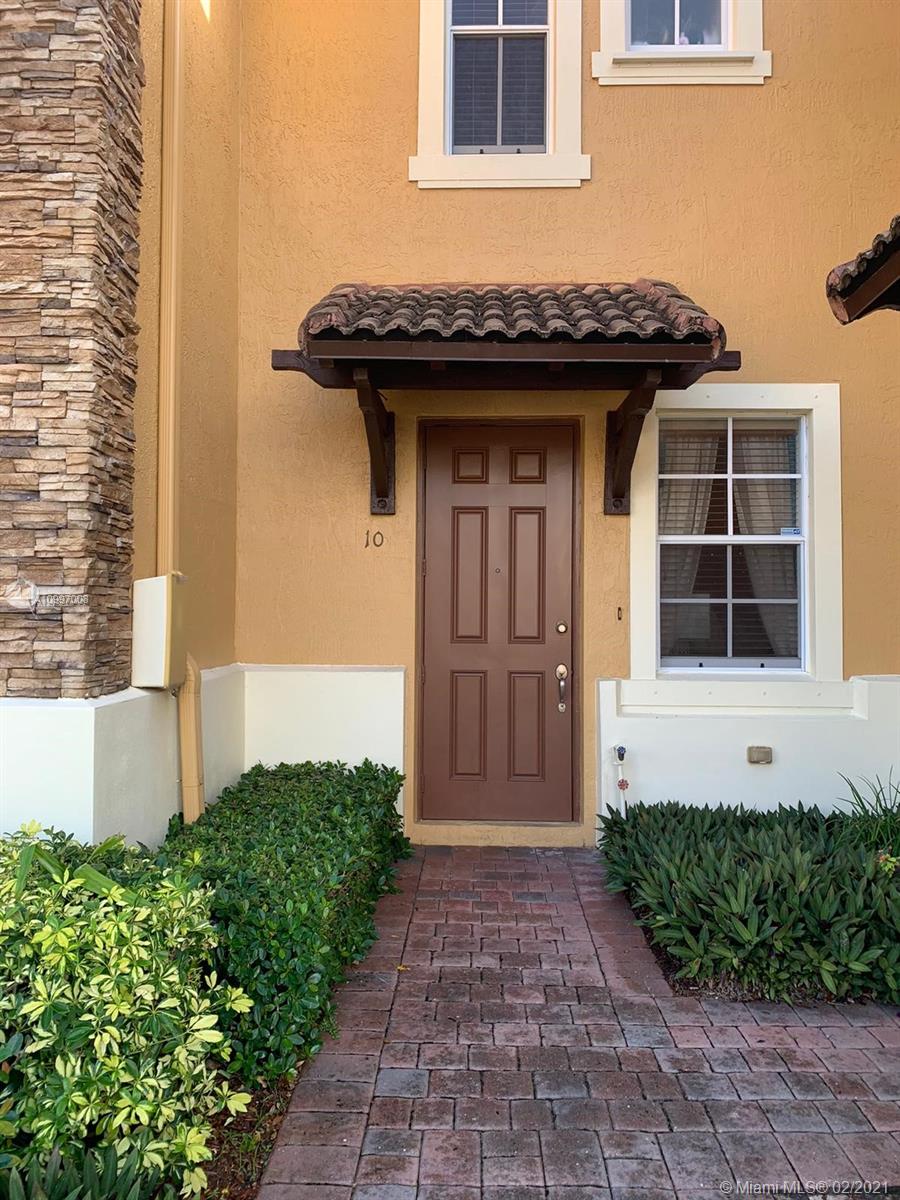9155 Southwest 227th Street, Unit 10 Cutler Bay, FL 33190 - Photo 1 of 7 a front view of a house with a garden