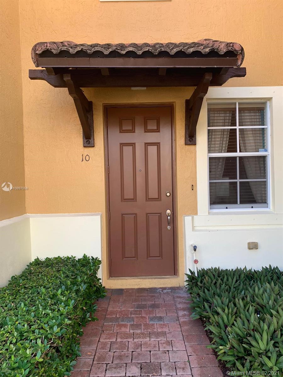 9155 Southwest 227th Street, Unit 10 Cutler Bay, FL 33190 - Photo 2 of 7 a front view of a house with a yard
