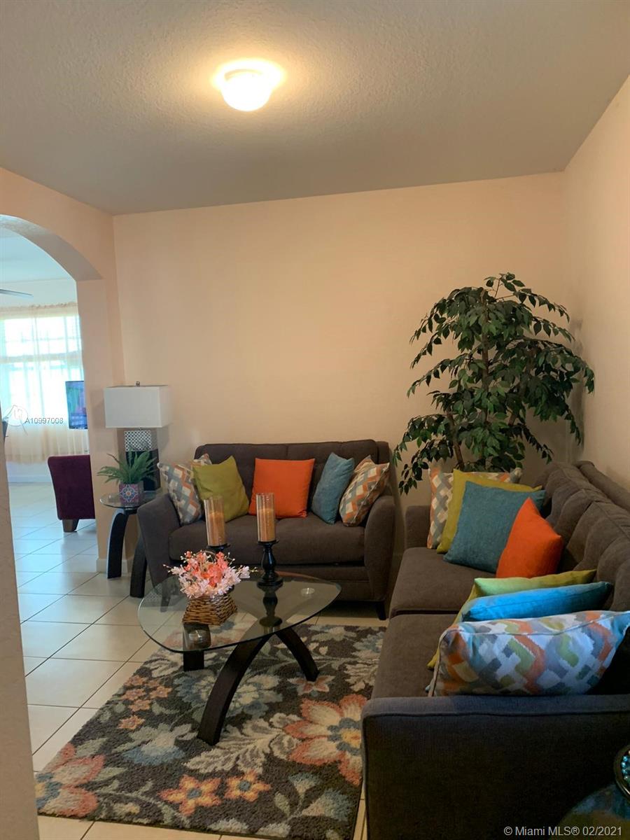 9155 Southwest 227th Street, Unit 10 Cutler Bay, FL 33190 - Photo 3 of 7 a living room with furniture and a rug