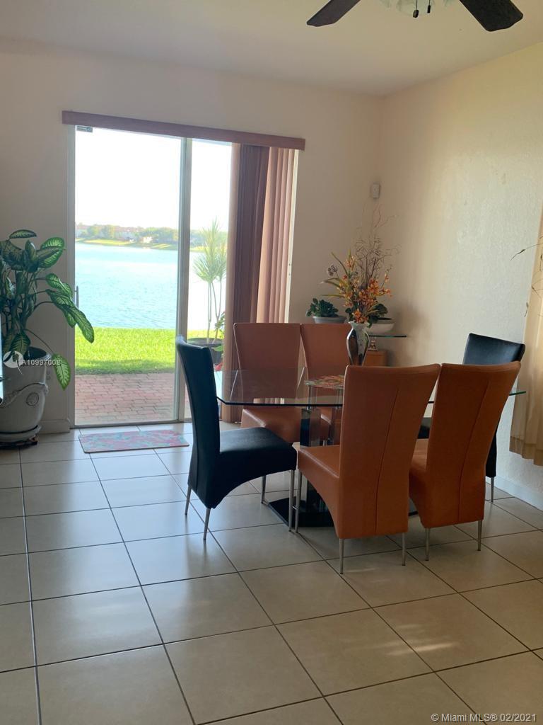 9155 Southwest 227th Street, Unit 10 Cutler Bay, FL 33190 - Photo 6 of 7 a living room with furniture and a window