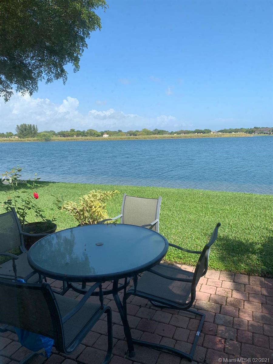9155 Southwest 227th Street, Unit 10 Cutler Bay, FL 33190 - Photo 7 of 7 a view of a chairs and table in patio