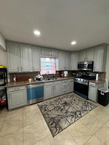 a bedroom with a bed window and couch