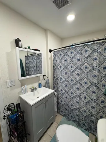 a living room with furniture kitchen view and a window