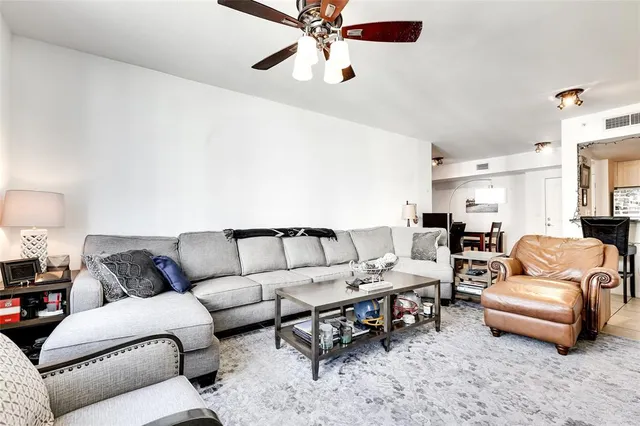 a bedroom with a bed and a flat tv screen on dresser