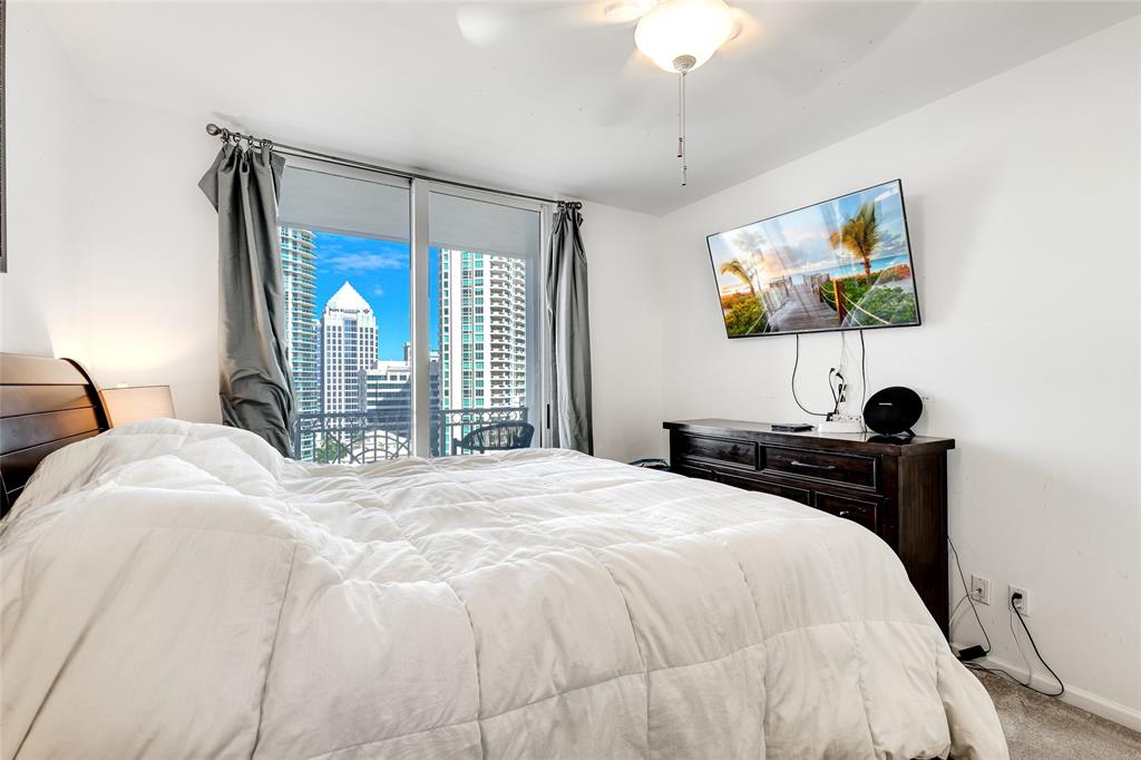 511 Southeast 5th Avenue, Unit 1602 Fort Lauderdale, FL 33301 - Photo 13 of 66 a bedroom with a bed and a flat tv screen on dresser