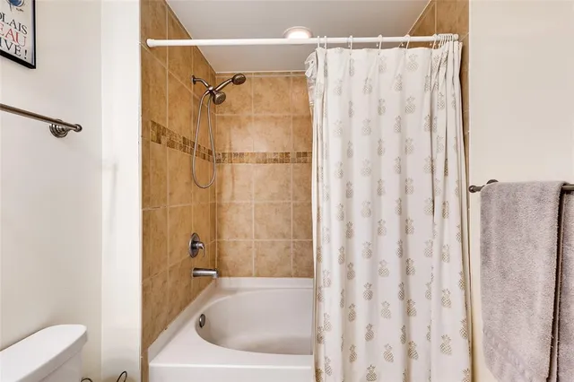 a bedroom with a bed a chandelier and a window