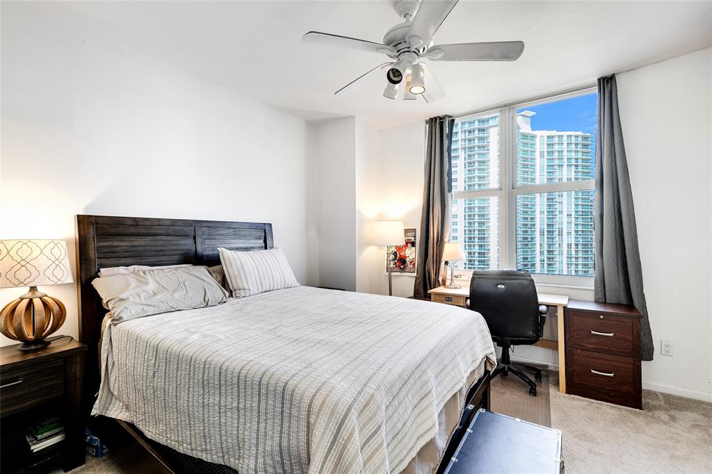 511 Southeast 5th Avenue, Unit 1602 Fort Lauderdale, FL 33301 - Photo 16 of 66 a bedroom with a bed a chandelier and a window