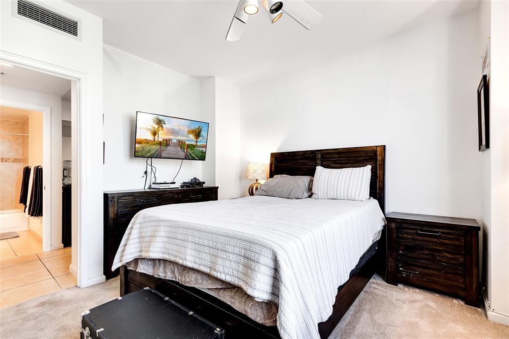 511 Southeast 5th Avenue, Unit 1602 Fort Lauderdale, FL 33301 - Photo 17 of 66 a bedroom with a bed and a flat screen tv