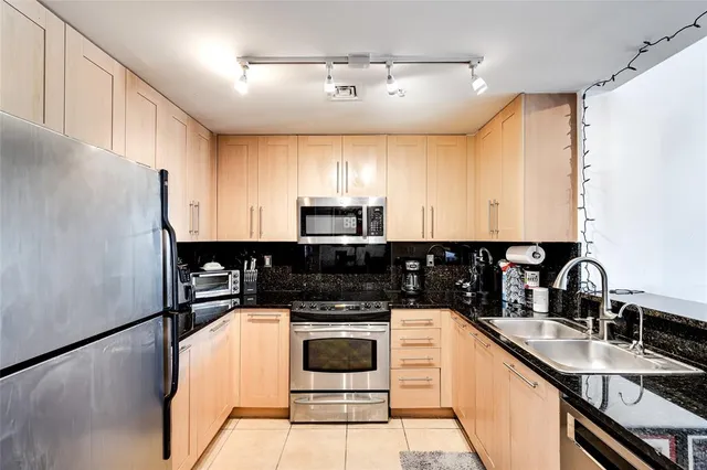 a kitchen with granite countertop a stove and a microwave