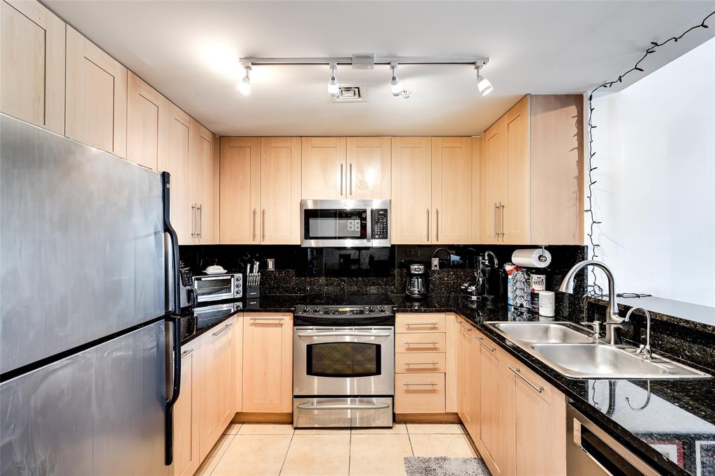 511 Southeast 5th Avenue, Unit 1602 Fort Lauderdale, FL 33301 - Photo 4 of 66 a kitchen with a sink a stove and cabinets