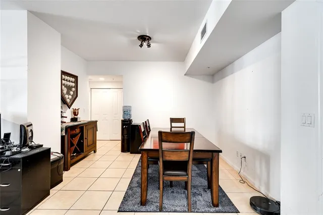 a dining room with kitchen island a table and chairs in it