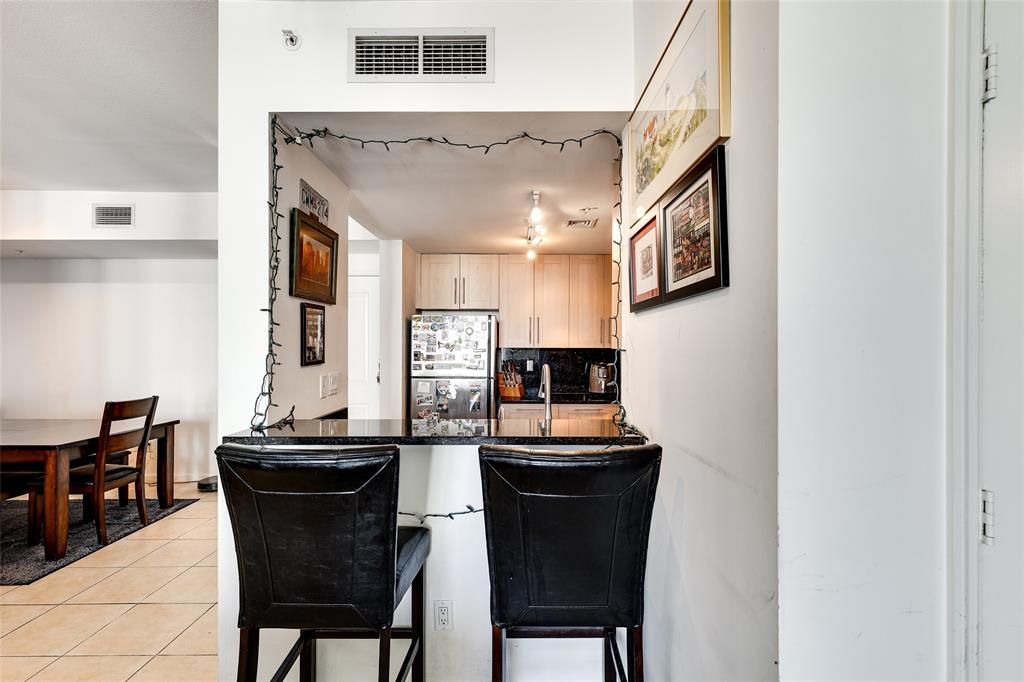 511 Southeast 5th Avenue, Unit 1602 Fort Lauderdale, FL 33301 - Photo 9 of 66 a dining room with kitchen island a table and chairs in it