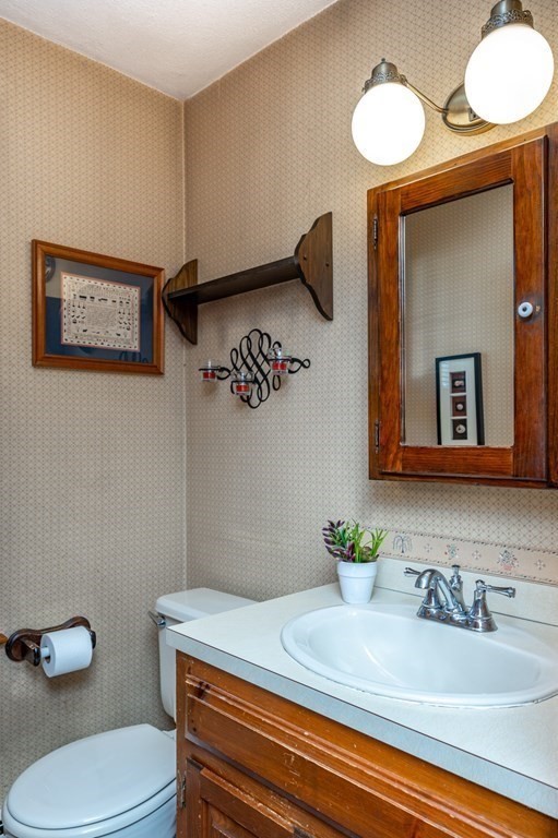 113 Gayland Road Needham, MA 02492 - Photo 11 of 32 a bathroom with a sink a toilet and mirror
