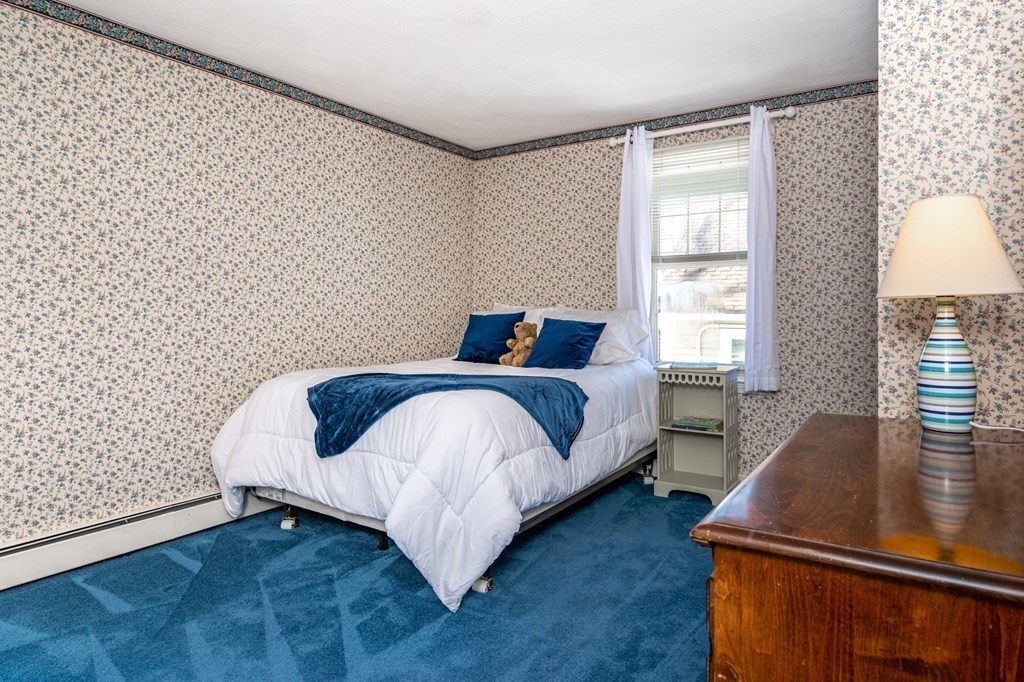 113 Gayland Road Needham, MA 02492 - Photo 16 of 32 a bedroom with a bed and a night stand