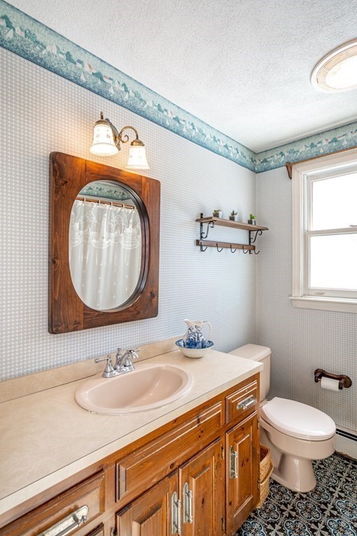 113 Gayland Road Needham, MA 02492 - Photo 18 of 32 a bathroom with a toilet sink and mirror