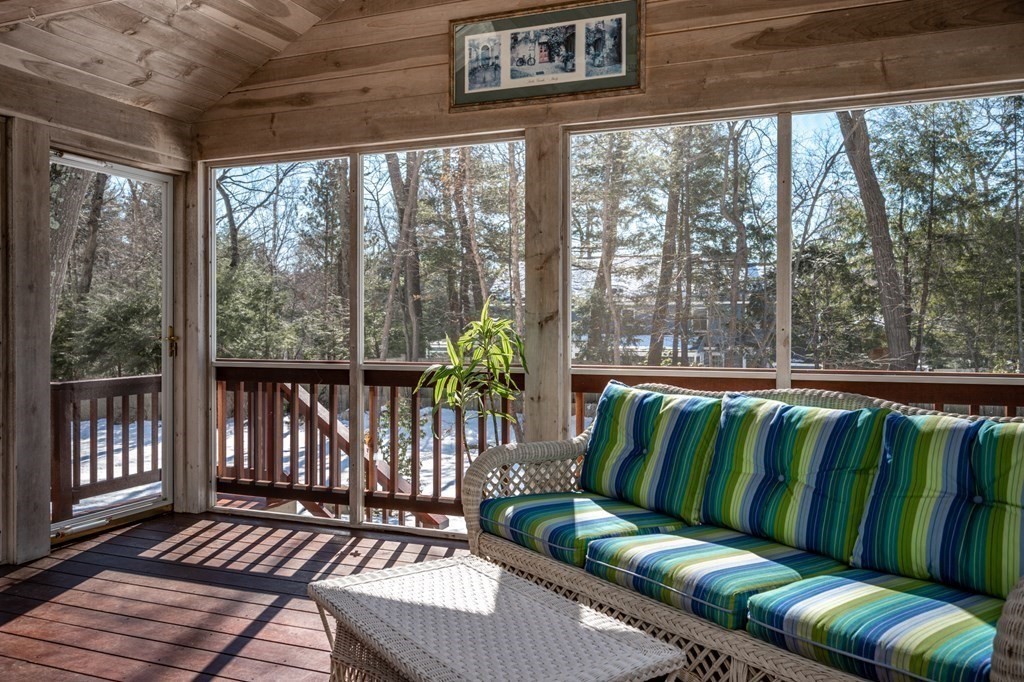 113 Gayland Road Needham, MA 02492 - Photo 19 of 32 a balcony with couch and wooden floor