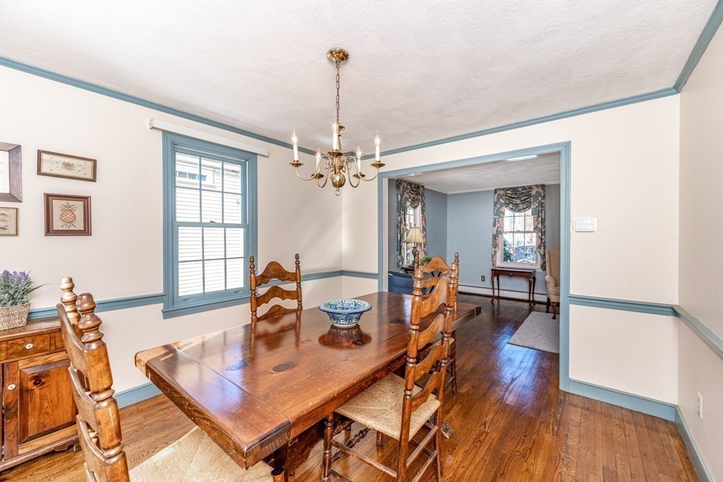113 Gayland Road Needham, MA 02492 - Photo 4 of 32 a view of a dining room and livingroom with furniture wooden floor a chandelier