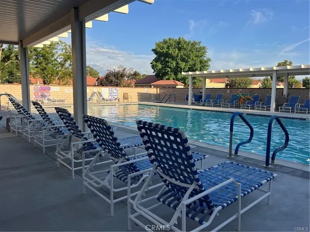 a living room with furniture a flat screen tv and a table