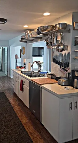a kitchen with stainless steel appliances granite countertop a sink and a stove