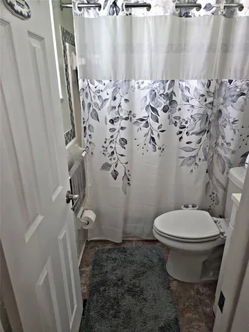 a bathroom with a toilet and shower