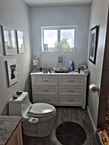 a bathroom with a toilet a sink and mirror