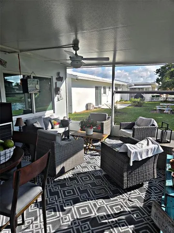 a living room with furniture and a floor to ceiling window