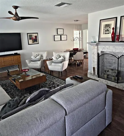 a living room with furniture fireplace and window