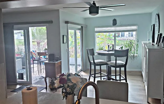 a view of a dining room with furniture large window and wooden floor