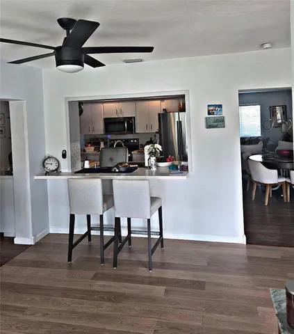 a view of a dining room with furniture and wooden floor