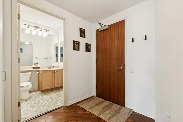 a bathroom with a sink and mirror with toilet