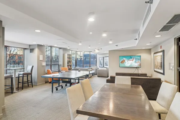 a living room with furniture a large window and table