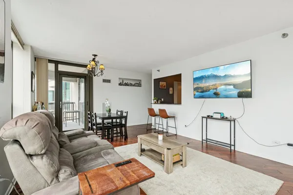 a living room with furniture and wooden floor