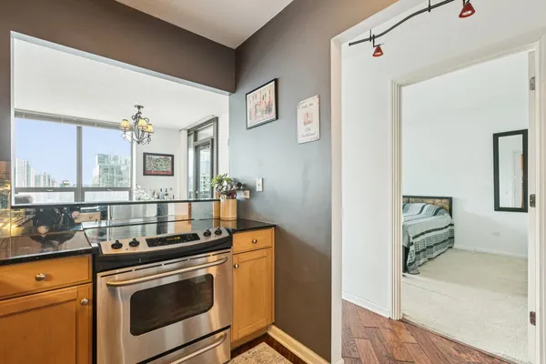 a kitchen with stainless steel appliances granite countertop a stove and a sink