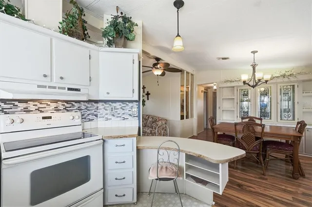 a kitchen with stainless steel appliances granite countertop a sink and cabinets