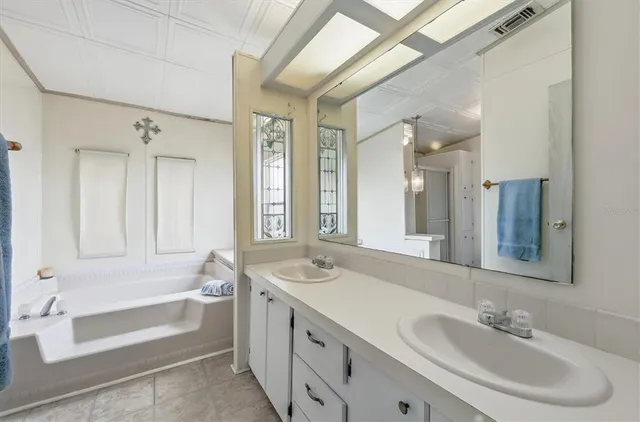 a bathroom with a shower sink and mirror