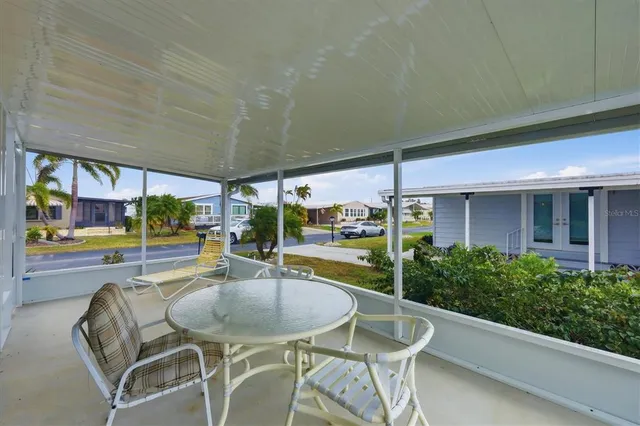 a view of a house with swimming pool and sitting area