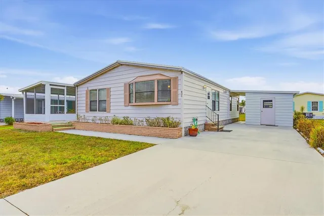 a view of a patio with table and chairs under an umbrella